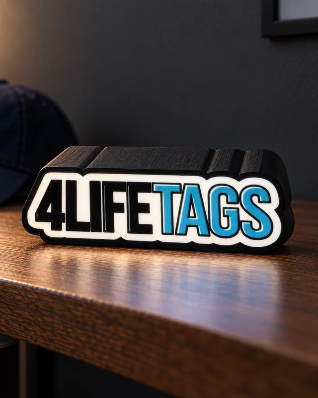 Illuminated 4LIFETAGS logo lightbox with black printed enclosure on a wooden shelf