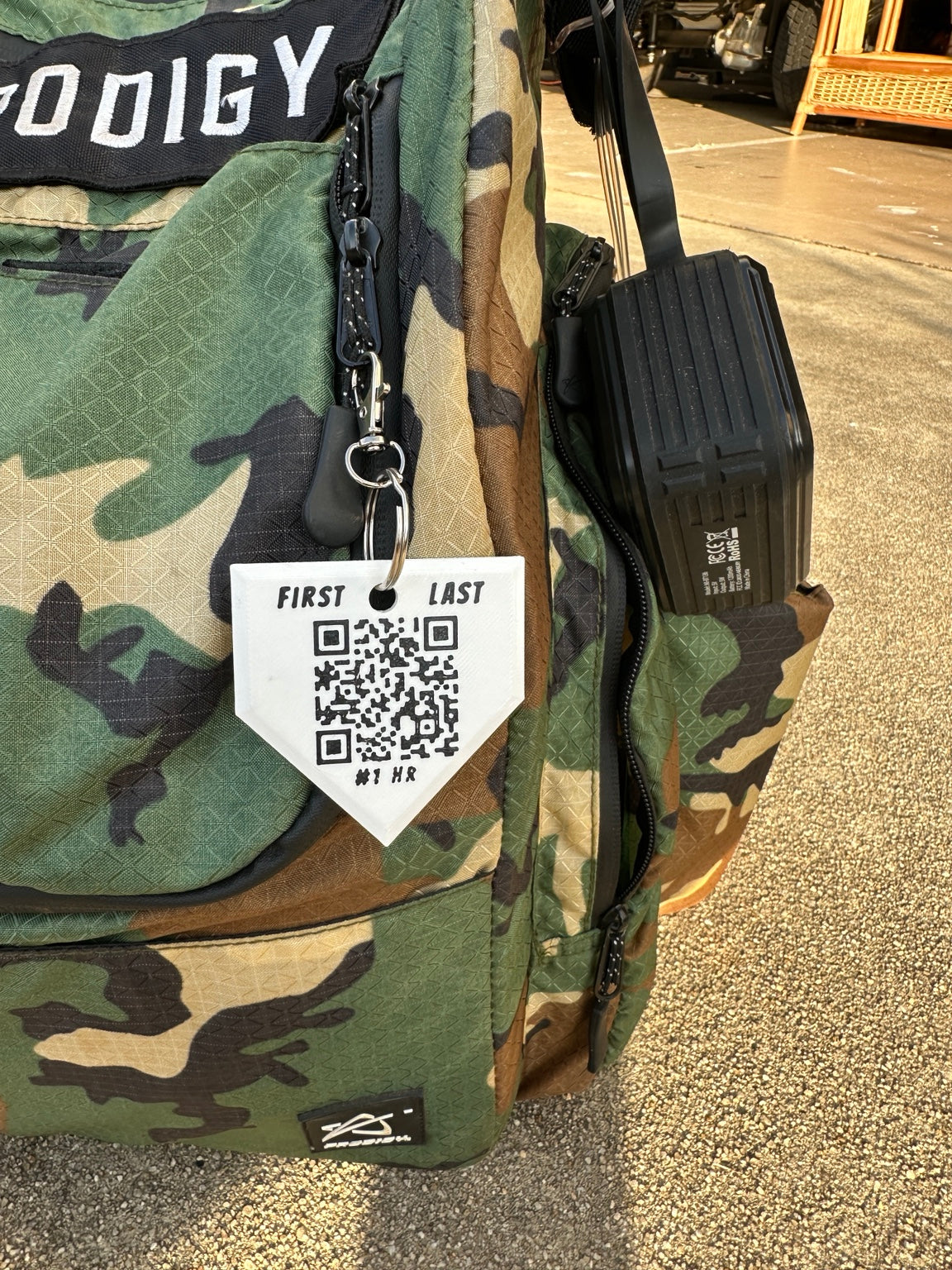 Camouflage bag with a QR code tag on a textured surface